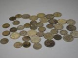 a pile of coins on a table with a white background