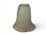 a small glass bell on a white surface