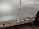 a car that has been dented and is in a garage