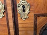 a close up of a wooden cabinet with a keyhole on it