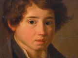 portrait of a young boy in a black shirt and a brown jacket