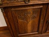 a wooden cabinet with a mirror on top of it