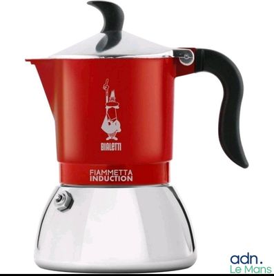 a red and white stove top coffee maker with a black handle