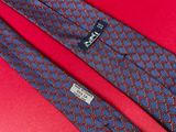 a close up of a tie on a red surface