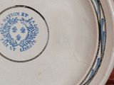 a blue and white plate on a wooden table
