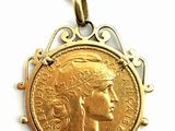 an image of a necklace with a gold coin on a chain