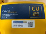 a close up of a yellow box on a table with a sticker on it