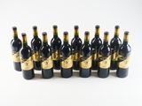 six bottles of wine are lined up in a row on a white surface