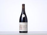 the bottle of red wine is sitting on the table