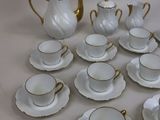 a lot of cups and saucers that are on the table