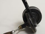 a small black object with a wooden handle on a white surface