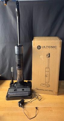 an image of a vacuum cleaner sitting on top of a table next to a box