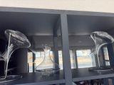 three glass vases on a shelf in a room