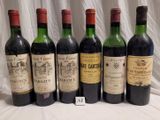 several bottles of wine are lined up on a table