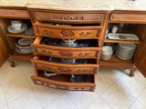 a wooden cabinet with a marble top and a marble counter top