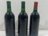 three bottles of wine sitting next to each other on a table