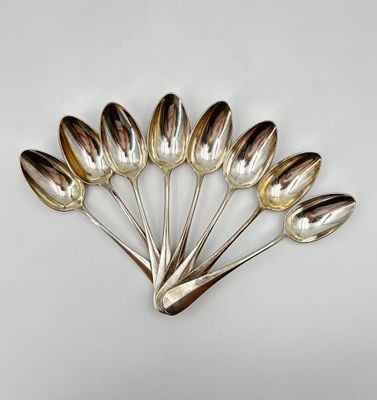 five spoons in the shape of tulips on a white surface