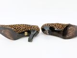 a pair of leopard print shoes with a bow on the heel