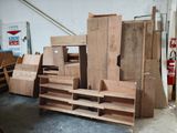 several pieces of wood are stacked on top of each other in a garage