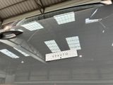 a sign on the hood of a car in a garage