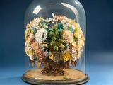 a glass cloche with a bunch of flowers inside of it