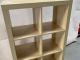 a close up of a wooden shelf with several shelves on it
