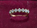 a close up of a gold ring with diamonds on it