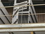 a man that is standing on a ladder in a building