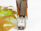a watch that is sitting on top of a leaf