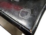 a close up of a black table with a red apple on it
