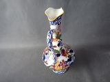a blue and white vase with flowers on it
