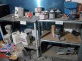 a metal shelf with various items on it in a room