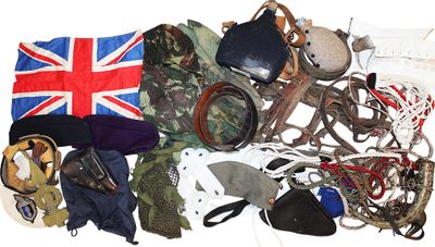 a pile of assorted military items on a white surface