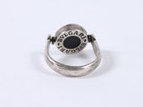 an image of a silver ring with a black stone in it