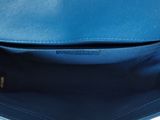 the inside of a blue leather purse with a zipper