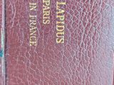 a close up of a red book with gold lettering on it