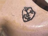 a tattoo on the back of a man ' s chest