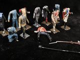 a lot of figurines that are sitting on a black surface