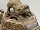 a bronze statue of a dog on top of a box