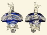 pair of crystal figurines of a man and a woman on a boat