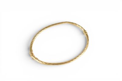 a close up of a gold bracelet on a white surface