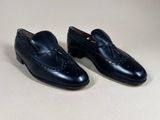 men ' s black leather loafers with tassels on the sole