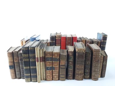 a lot of old books stacked on top of each other