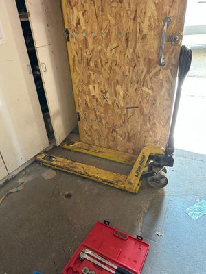 a red tool box sitting on the floor in front of a door