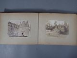 an old photo of a book opened to show a picture of a castle
