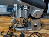 a mixer sitting on a wooden table in a kitchen