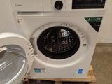 a washing machine sitting on a pallet in a room
