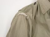 an image of a man ' s jacket hanging on a wall