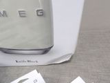 a white box with a cup on it next to a cup of coffee