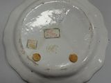 a white plate with a picture on it on a table